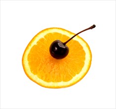 Slice of orange with cherry on top isolated on white background