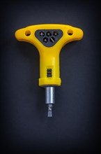 Yellow hand screwdriver Aerial view on black background