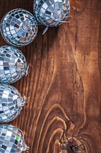 Christmas toy mirror disco balls on old wooden board with copy space