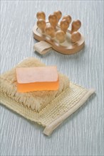 Massager and soap on raffia