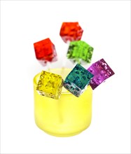 Bounch of colorfull translucent dice shaped lollipops backlit on white background
