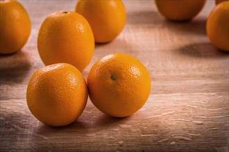 Horizontal version fresh ripe tasty orange fruits on wooden board