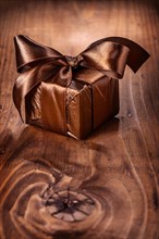 Small gift box on an old wooden board