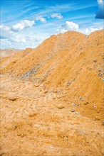 View of the pile of building sand and the sky