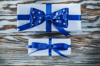 Blue gift boxes with bows on wooden board