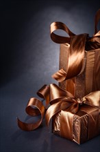 Brown gift boxes on black background with copy area