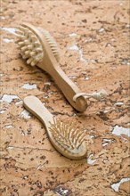 Massager and hairbrush on cork wood