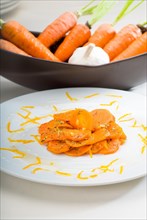 Fresh and healthy Honey glazed carrots on a plate with tyme on top