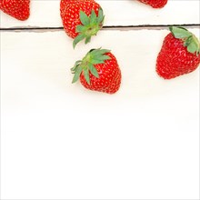 Fresh organic strawberry over white rustic wood table