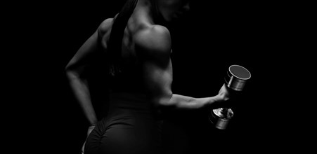 Black and white image of a sports girl on a black background. Fitness concept. Mixed media