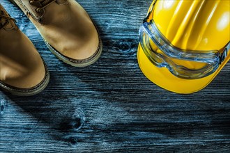 Safety glasses boots hard hat on wooden board