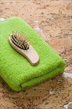 Hairbrush on green towel