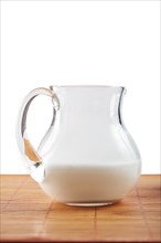 Small jug with milk isolated on the table