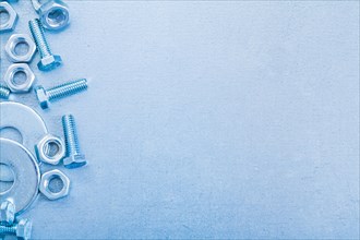 Metallic background with screwbolts bolt washers and construction nuts copy space image repairing concept