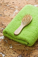 Towel and hairbrush on cork wood