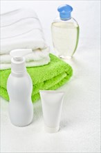 Bottle tube and cotton towels on a white background