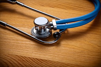 Close-up of classic stethoscope on wooden board medical concept