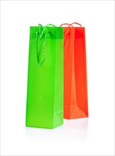 Green and yellow paper bags against a white background