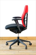 Modern red office chair on wood floor over white background