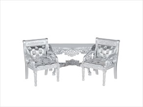 Two silver leather upholstery chairs with silver table on middle