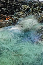 Turquoise fishing net and lobster baskets
