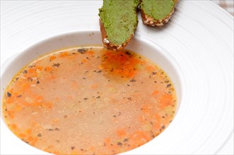 Classic Italian minestrone passato soup with pesto crostini on side