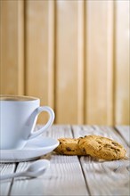 Coffee cup and cookies on old white table
