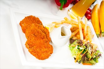 Classic breaded Milanese veal cutlets with french fries