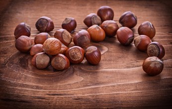 Composition of hazelnuts on vintage wooden board food and drink concept