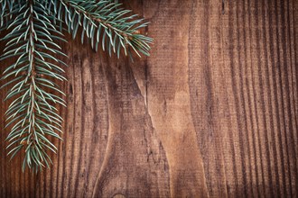 Copyspace Christmas background branches of fir tree on old wooden board horizontal version