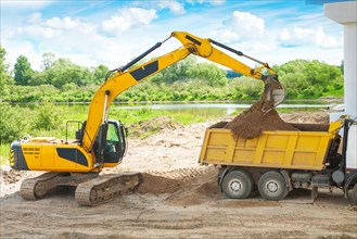 Excavator loading ground