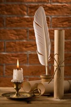 Candle with antique writing utensils