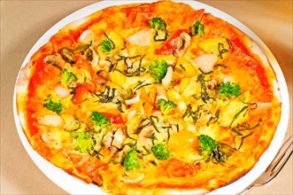 Fresh italian thin style vegetarian pizza with fresh mixed vegetables close up