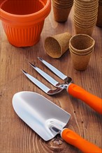 Gardening tools and pots on wooden boards