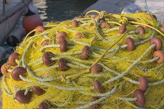 Yellow fishing nets with ropes and floats