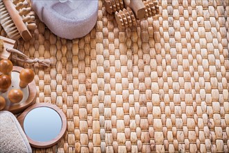 Hand glass wooden massagers brushes and soft bath sponges on wicker background sauna concept