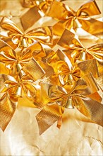 Many golden bows on paper background