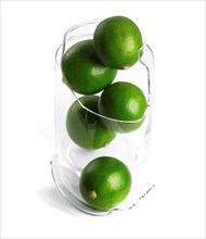 Shattered glass jar with lime on white background