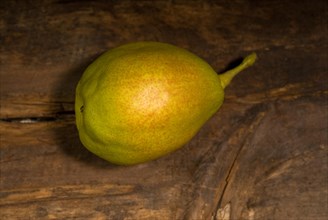 Autumn fresh pear over old wood board