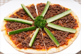 Fresh baked Turkish beef pizza with cucumber on top