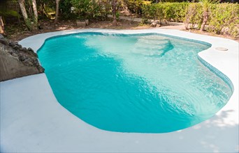 Swimming pool designs for the home. Home swimming pool maintenance concept. Homemade swimming pool in a garden