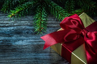 Gift box pine branch on wooden board