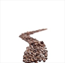 Bounch of roasted coffee beans mimic a road shape