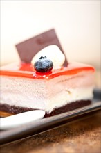 Fresh strawberry yogurt mousse with macaroon and blueberry on top