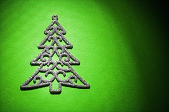 Christmas toy simbol of fir tree on green background horizontal version