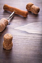 Champagne corks and corkscrew on vintage wooden board with copyspace alcohol concept