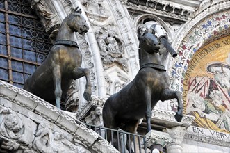 Quadriga of the horses of San Marco on St Mark's Basilica and the clock tower on St Mark's Square