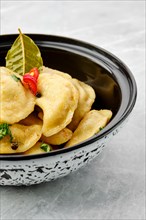 Closeup view of fried spicy dumplings in a bowl