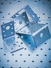 Stainless drilled angle fasteners on perforated sheet metal construction concept