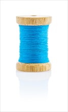 A small wooden spool with blue thread